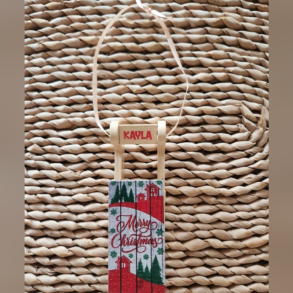 Merry Christmas Sled Ornament with Kayla in Red Lettering.